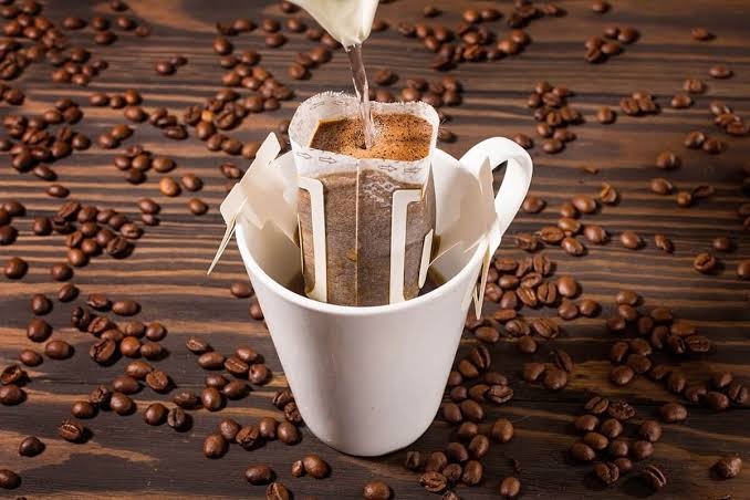 Single-serve drip coffee over a cup